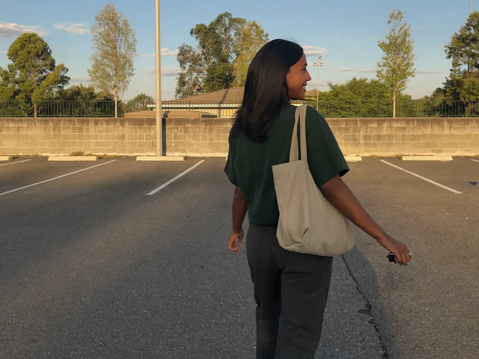 A veterinarian walking to her car at golden hour, done for the day